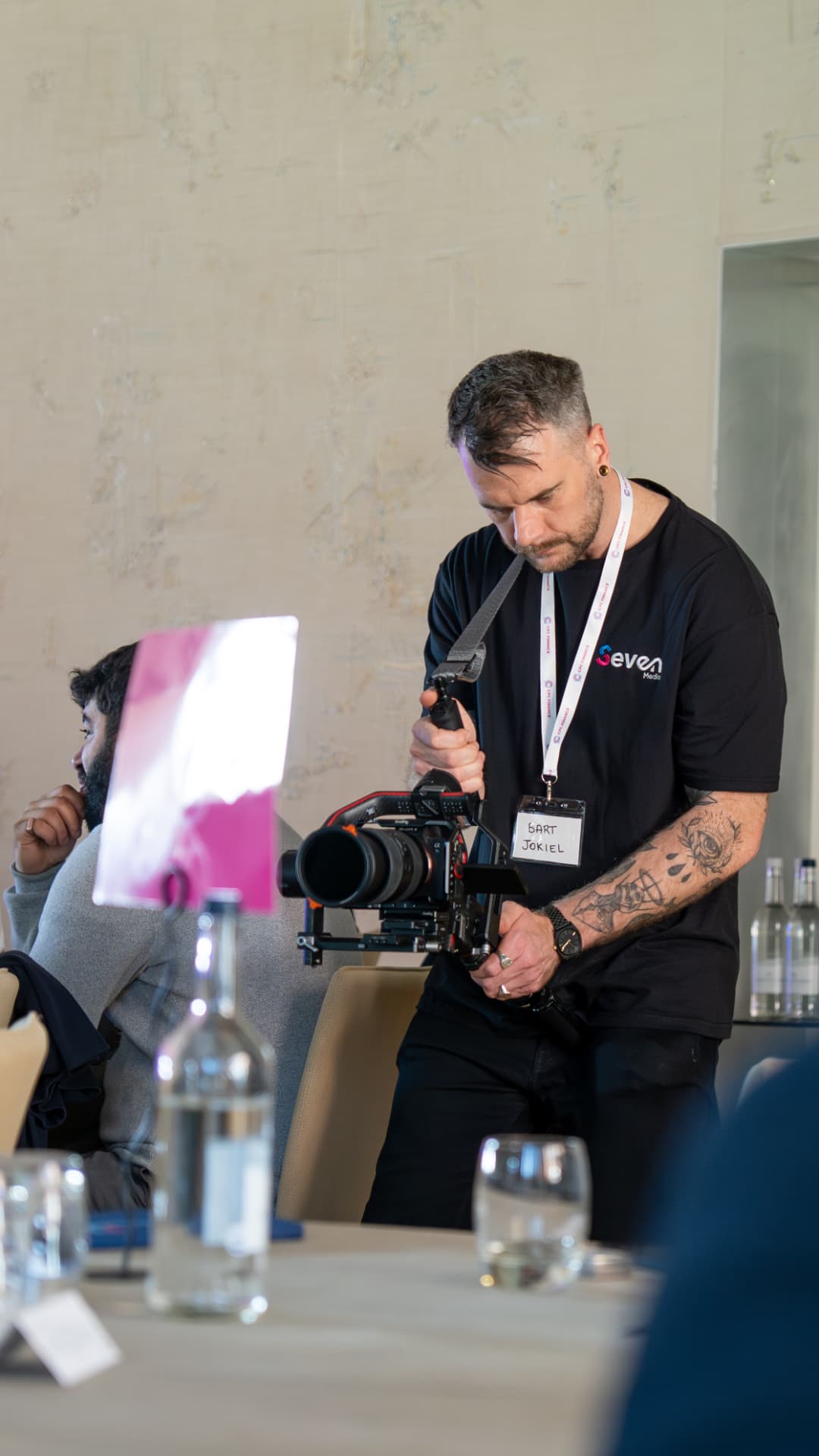 Seven Media camera operator filming during a client roundtable session